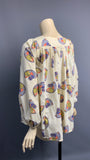Vintage 1970s novelty print balloon sleeved smock top or blouse - rainbows and cottages repeat pattern