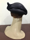C.1940s asymmetric navy blue hat with feather trim