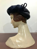 C.1940s asymmetric navy blue hat with feather trim